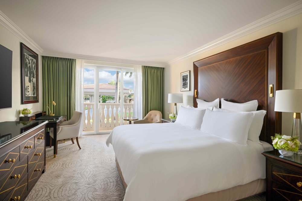 Elegant Deluxe King room featuring luxury bedding, Italian marble bath, premium amenities, and a balcony, lanai, or scenic resort views. 343–375 sq. f