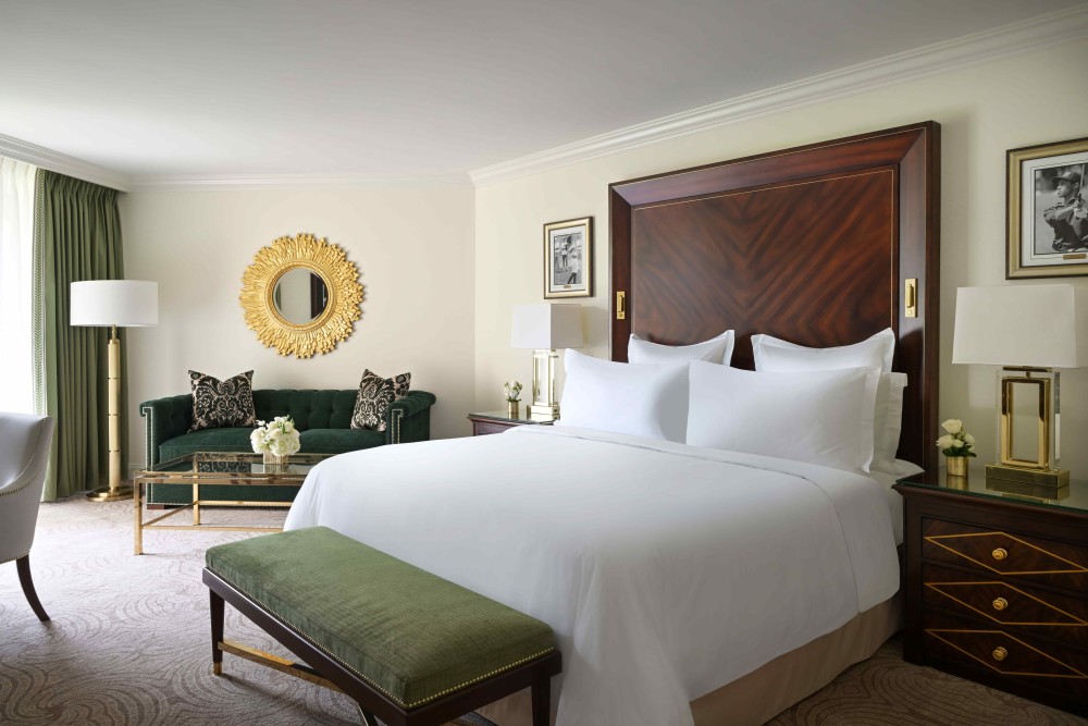 Elegant Premier King room with luxury bedding, Italian marble bath, premium amenities, and a private balcony or lanai with garden views. 433 sq. ft.