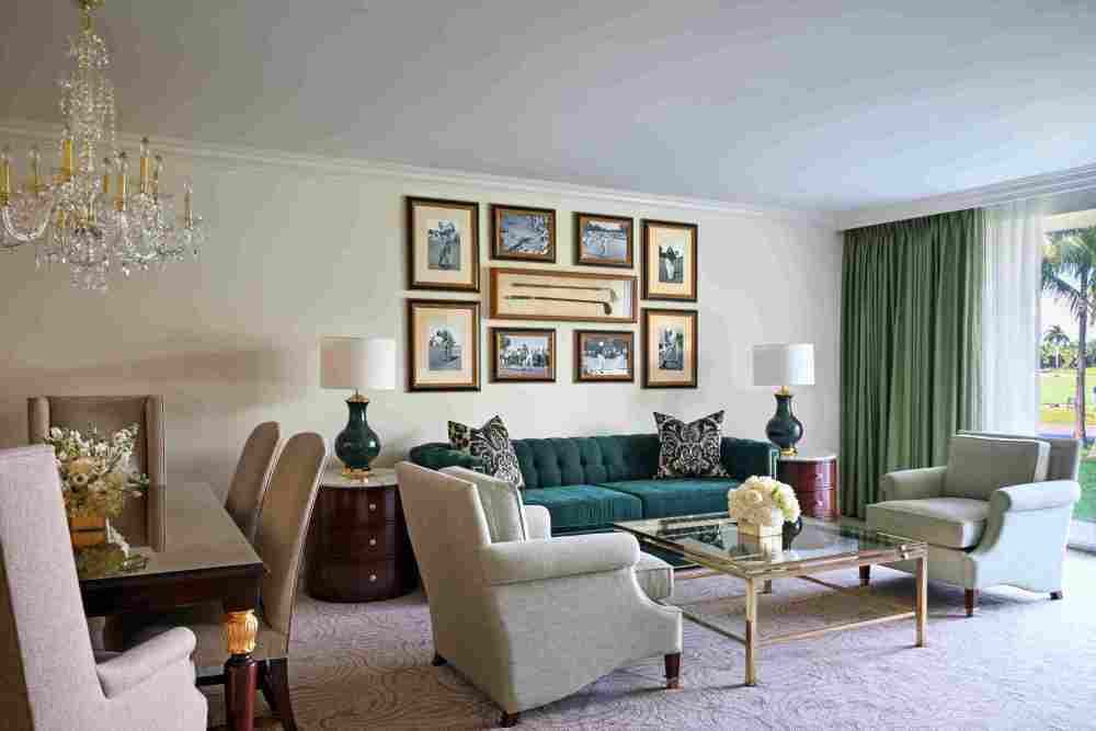 Spacious 1,295 sq. ft. Premier One-Bedroom Suite with king bed, separate living and dining areas, wet bar, marble baths, and garden or golf views.