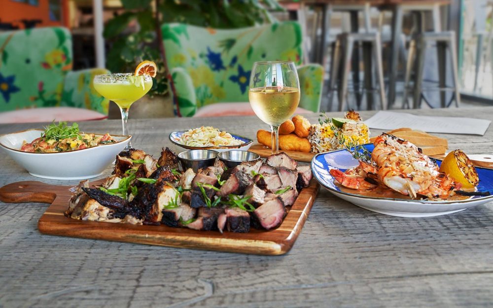 Assortment of delicious food from Dukunoo Jamaican Kitchen. Featured: Jerk Pork, Lemongrass Shrimp and more!