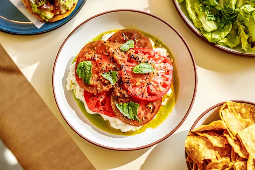 Heirloom tomatoes, burrata, white balsamic, ‘nduja tomato, basil, nigella seeds