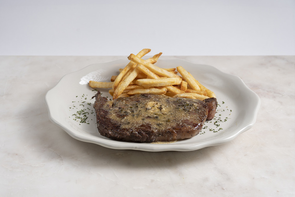 Juicy seared Entrecôte steak topped w/our Café de Paris Herb Butter