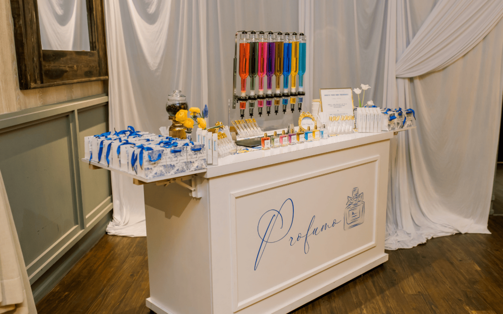 White and blue perfume bar setup with colorful fragrance options