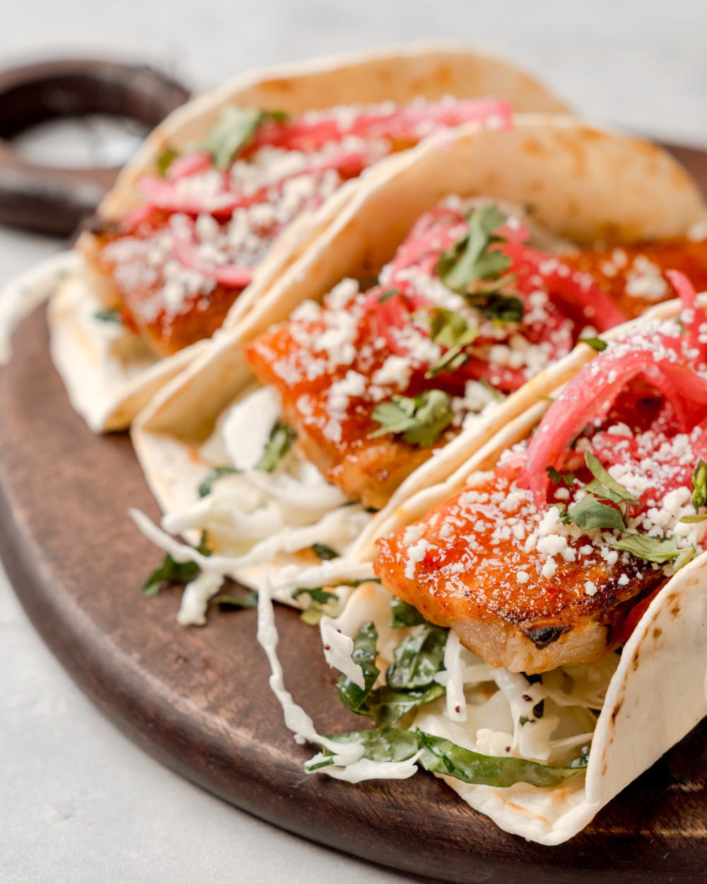 Poppy slaw, pickled onion, cotija cheese, flour tortilla
