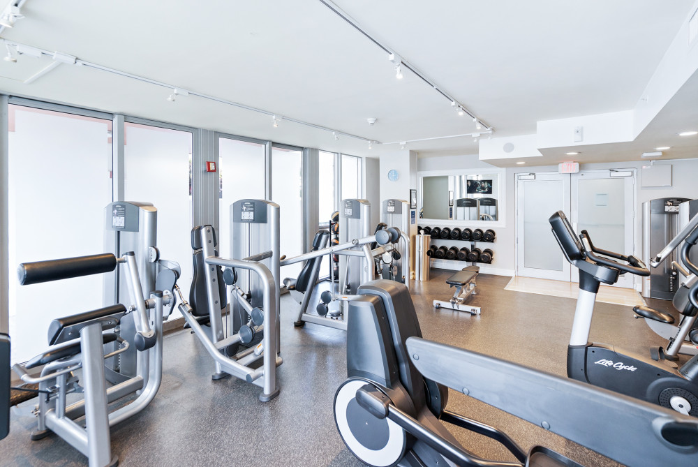 Intimate fitness center with Peloton bikes, cardio & strength equipment, plus a relaxing sauna
