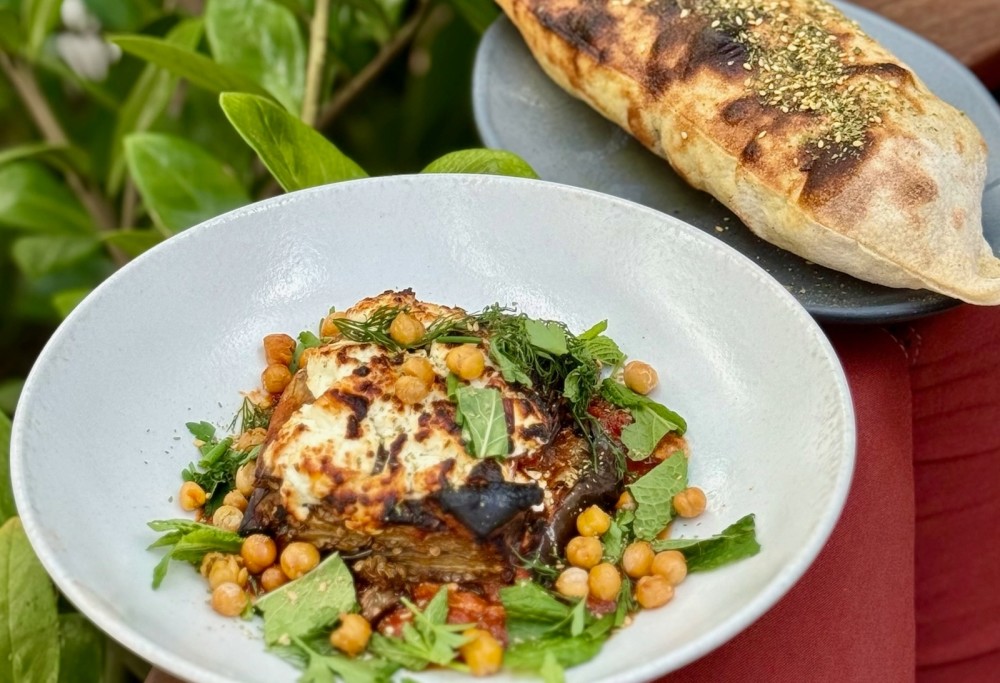 Wood oven roasted eggplant - tomato harissa, feta, herbs, chickpeas, zataar, pita