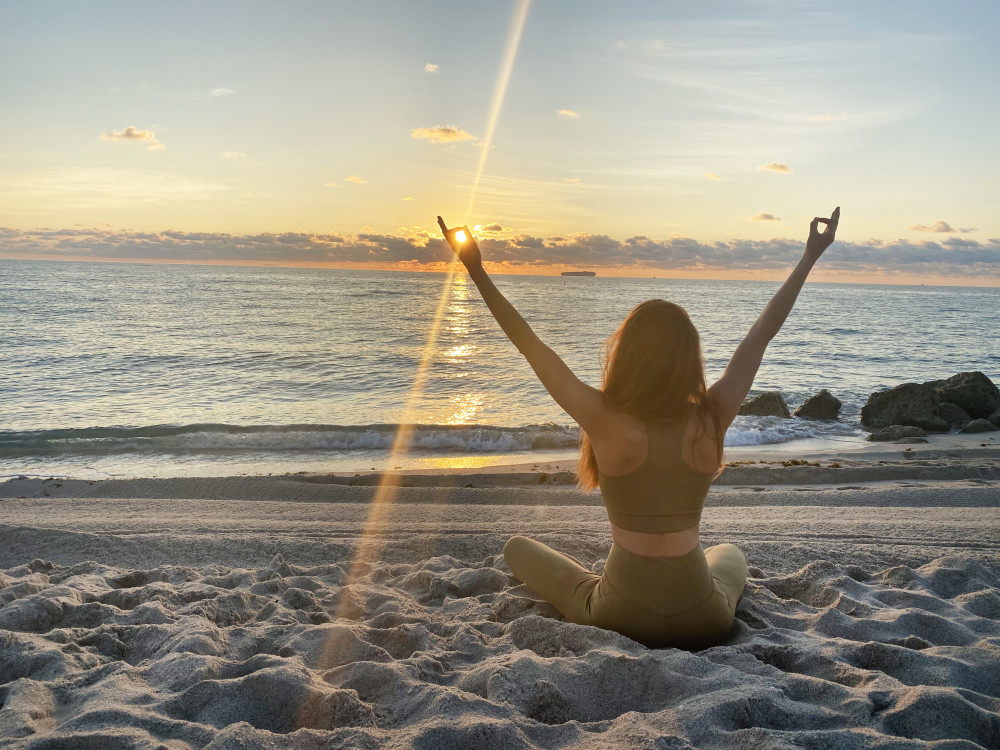 Girl on beach at sunrise
