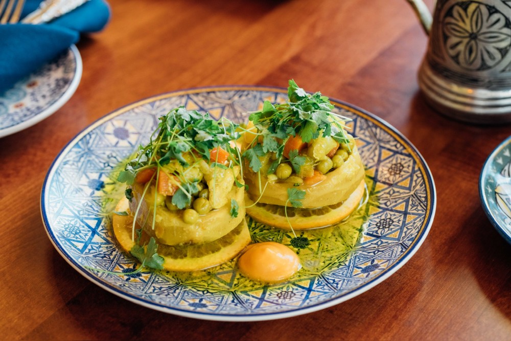 2pcs whole artichoke hearts, chopped carrot and potato, pearl onions, green peas, orange sauce, and garlic.