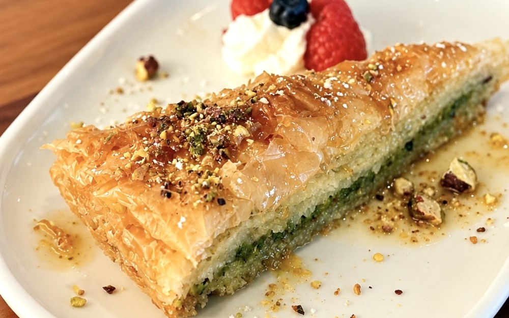 Crispy layers of golden phyllo, filled with pistachios and finished with a delicate honey syrup.