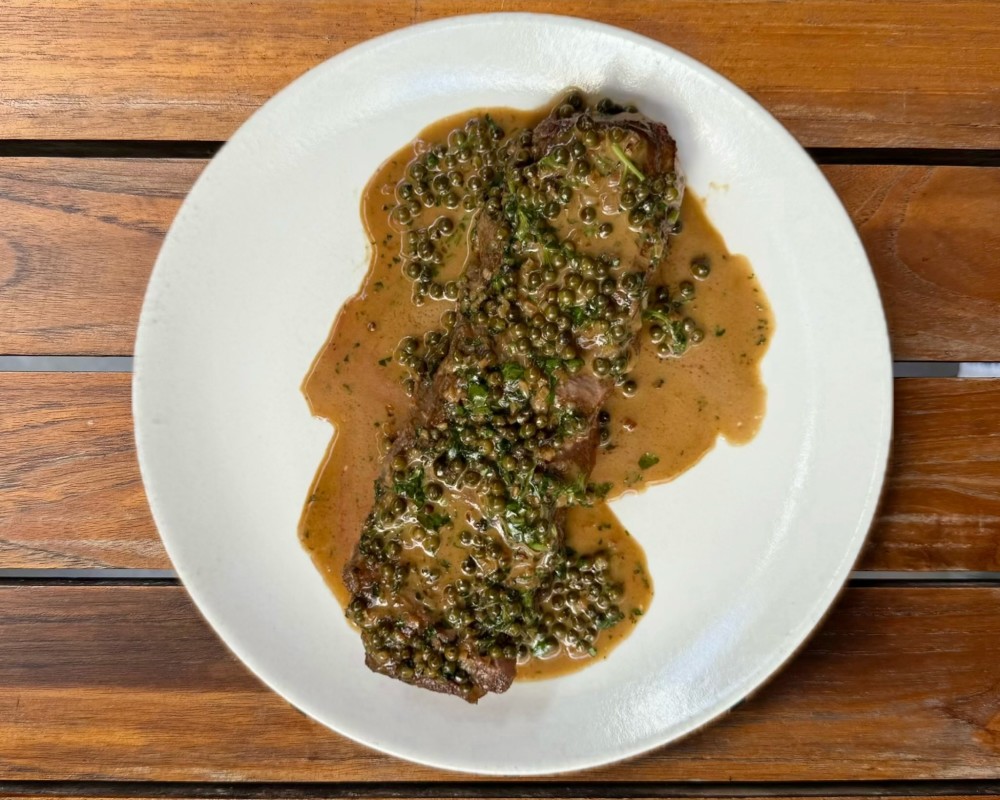 Steak au Poivre: 12 oz prime NY strip, served with a green peppercorn and brandy
