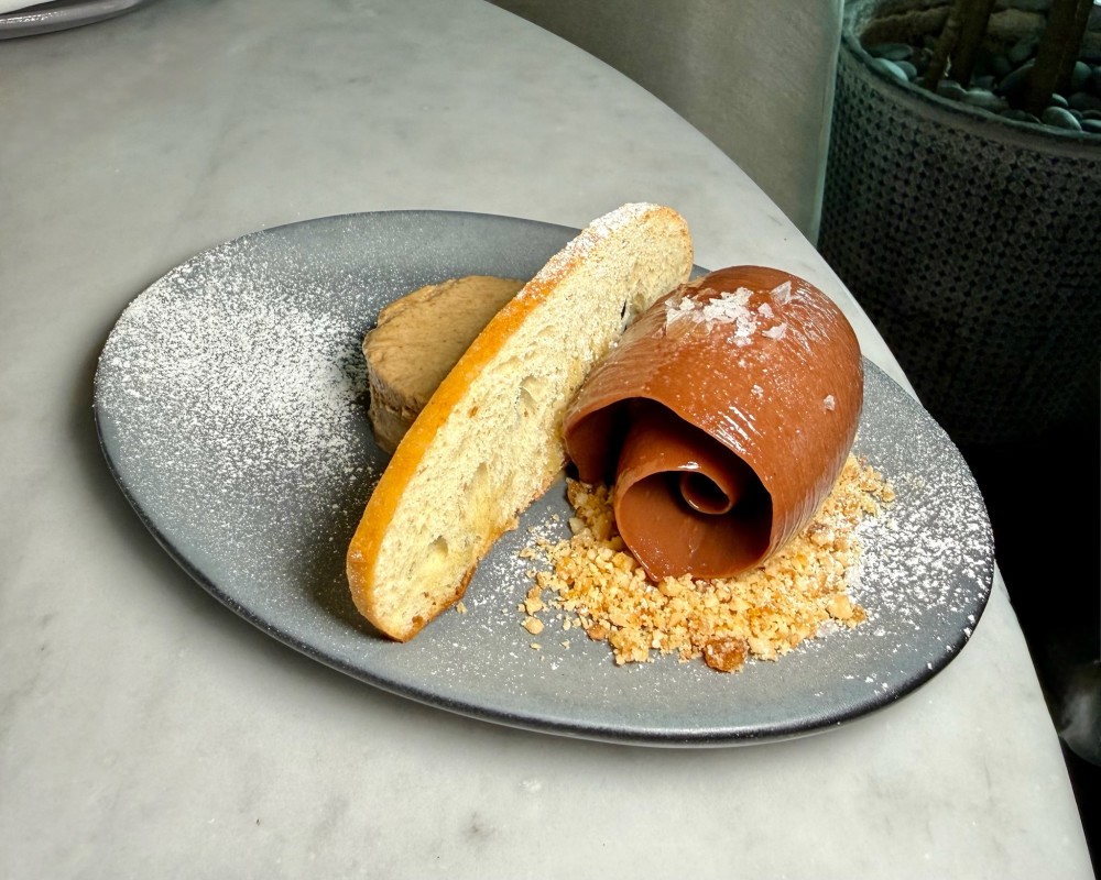 Milk chocolate cremoso with hazelnut praline, olive oil, sea salt, sourdough crostini