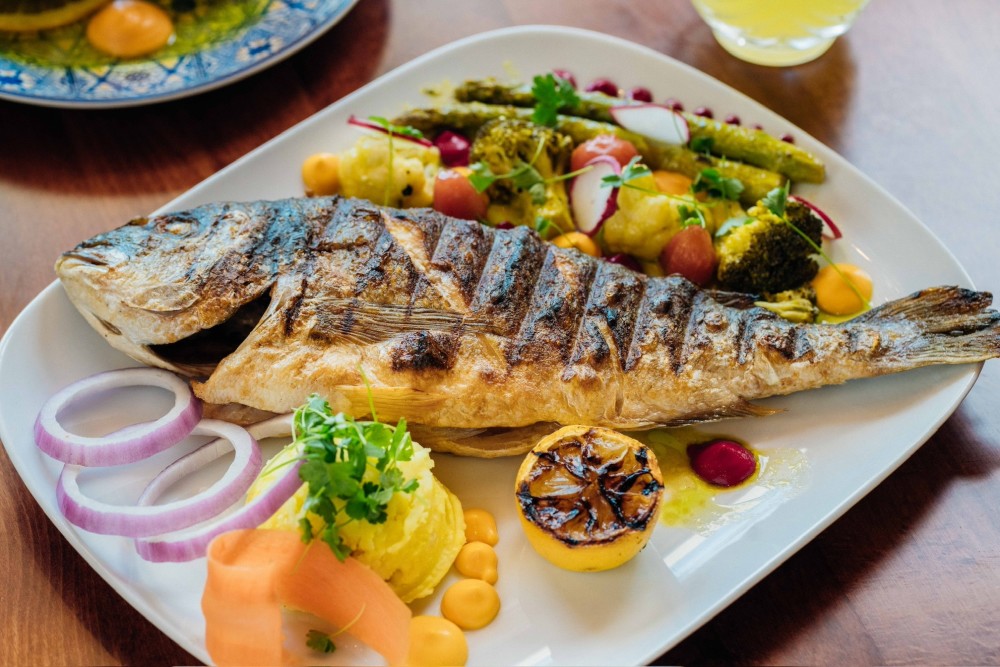Whole Mediterranean Dorada served with vegetable puree, sauteed vegies, fresh onion and mashed potato.