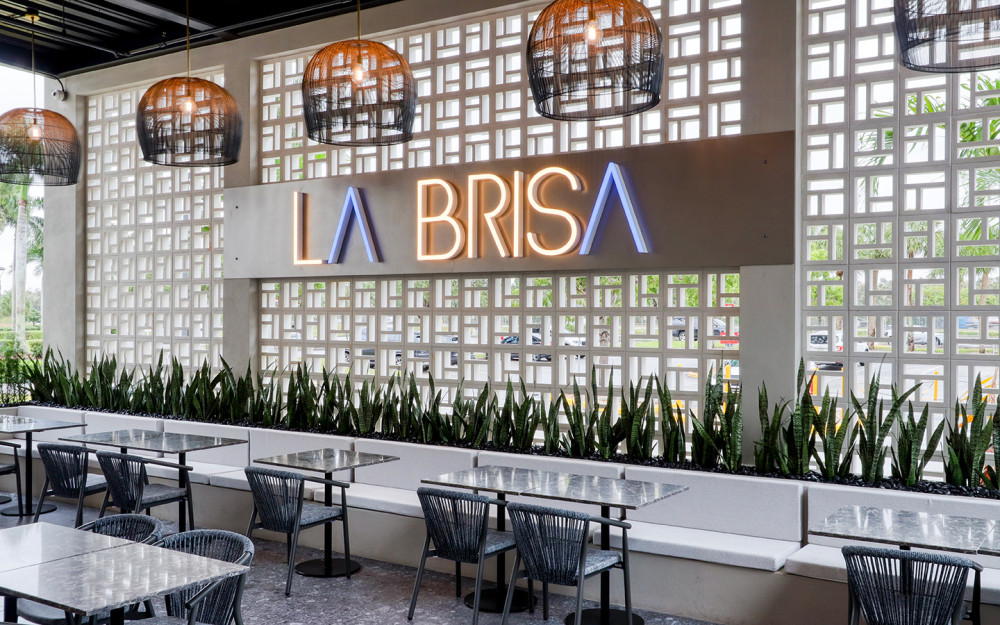 The restaurant boasts an al fresco patio and an open kitchen, allowing diners to witness the chefs in action as they prepare their meals.