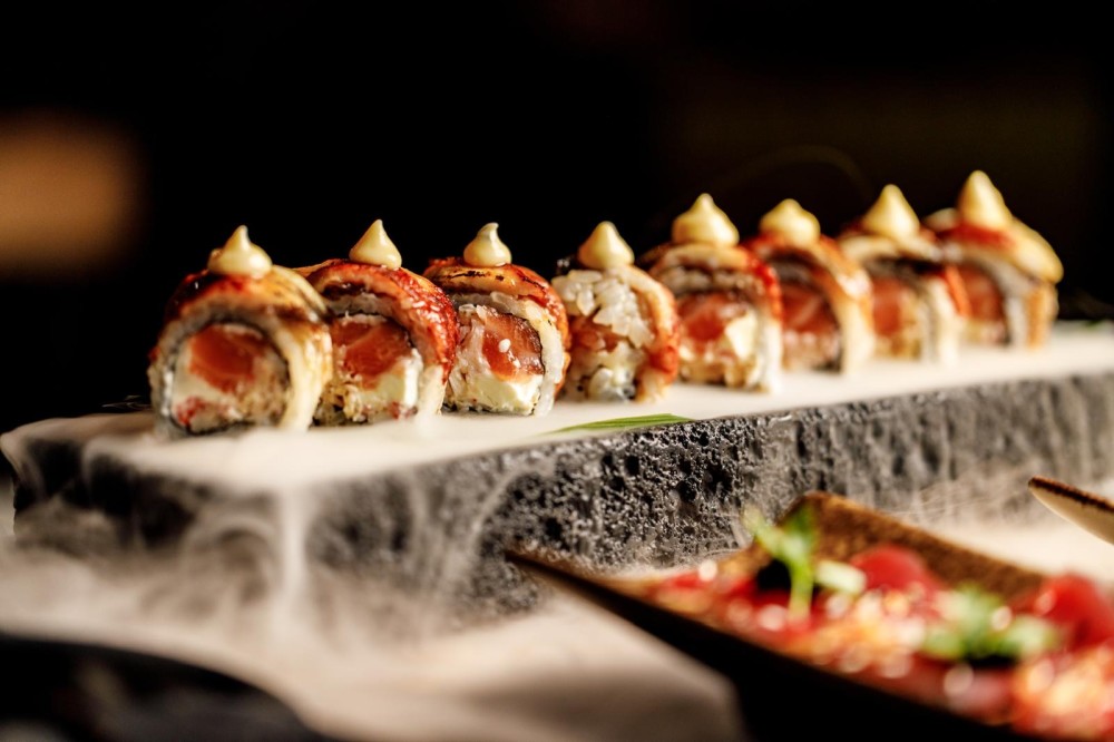 Fresh salmon, sweet crab, and silky cream cheese, wrapped and crowned with grilled unagi, glazed in rich eel sauce.