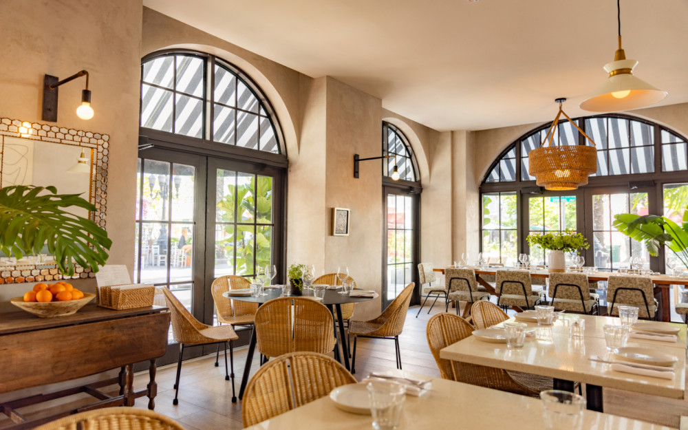 Step inside The Drexel—airy arches, woven textures, and lush greenery create a warm, inviting space on Miami Beach’s Española Way.