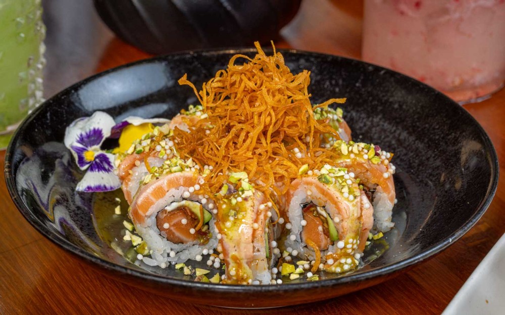 Reinventing sushi with Scottish salmon, smoked bacon, pistachio crust, cream cheese, avocado and crispy sweet potato—bold, fresh and delicious.