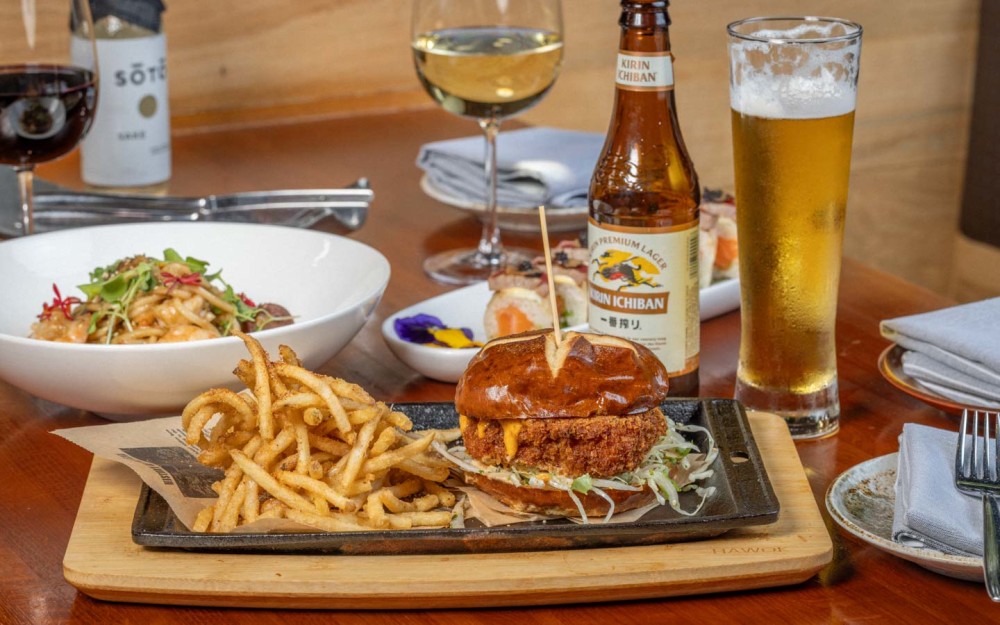 Crispy shrimp burger with nappa cabbage, spicy aioli, and nori on a pretzel bun—served with golden fries. A bold, irresistible twist on a classic!