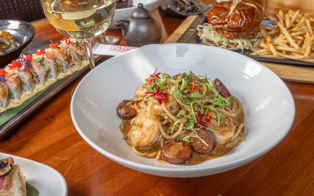 Indulge in our Mare y Terra Udon a rich, creamy miso lobster broth with shrimp, sausage, and mushrooms over tender noodles. Comfort with a bold twist