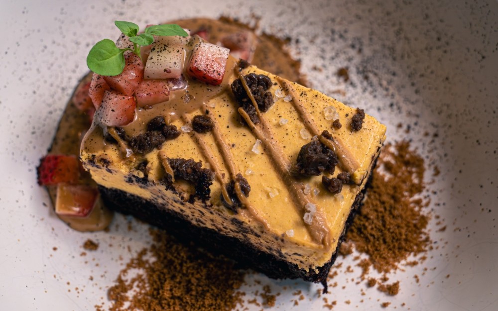Lúcuma mousse with white miso over organic chocolate cake, finished with miso dulce de leche, brownie crumble, and Maldon sea salt