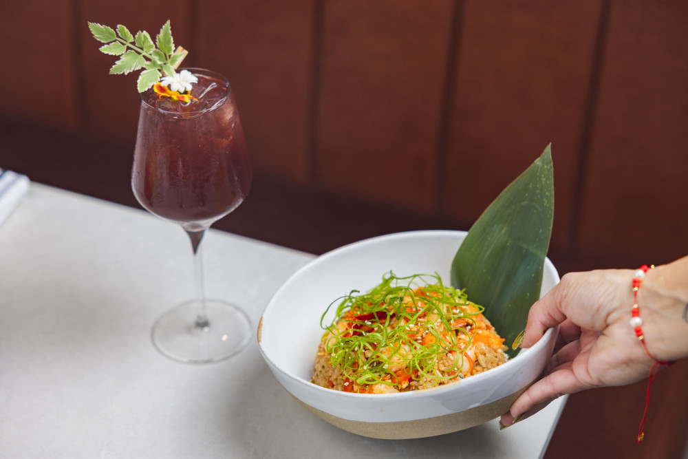 Pictured: our savory Lobster Chaufa Rice paired with the refreshing Limonada Morada mocktail — a perfect flavor combo.