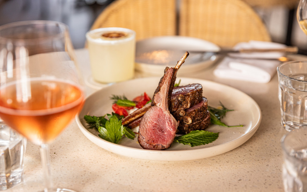 Savor herb-crusted lamb chops with a glass of rosé—refined flavors and relaxed elegance at The Drexel, Miami Beach