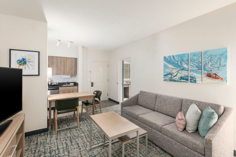 Suite Living Room Area featuring queen size pull out sofa bed, fully equipped kitchen and 50" TV