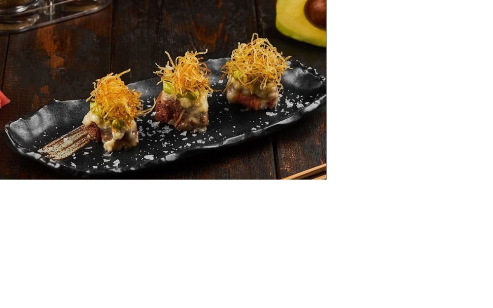 New York strip, avocado cream, crispy potato, and parmesan come together atop sushi rice