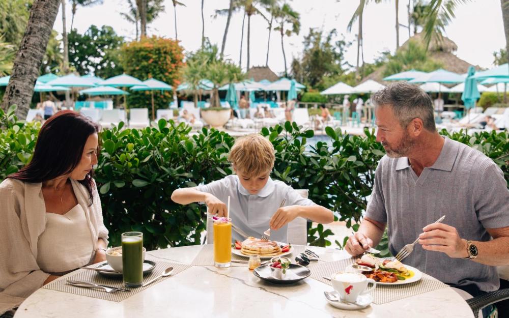 Mom, dad, and son dining at Essensia for brunch.