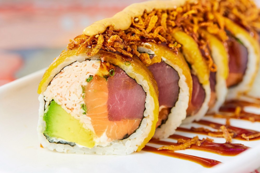 Fresh tuna, salmon, dynamite mix, avocado, cream cheese, scallions, fried sweet plantain, crispy carrots, chipotle sauce, Nacion signature sweet sauce