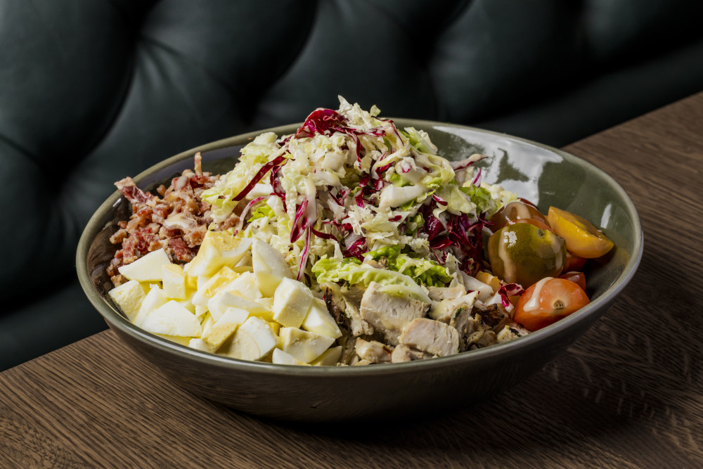 fresh Napa cabbage, radicchio, egg crumble, chopped bacon, blue cheese crumble, baby heirloom tomato, chilled chicken, citrus vinagrette dressing