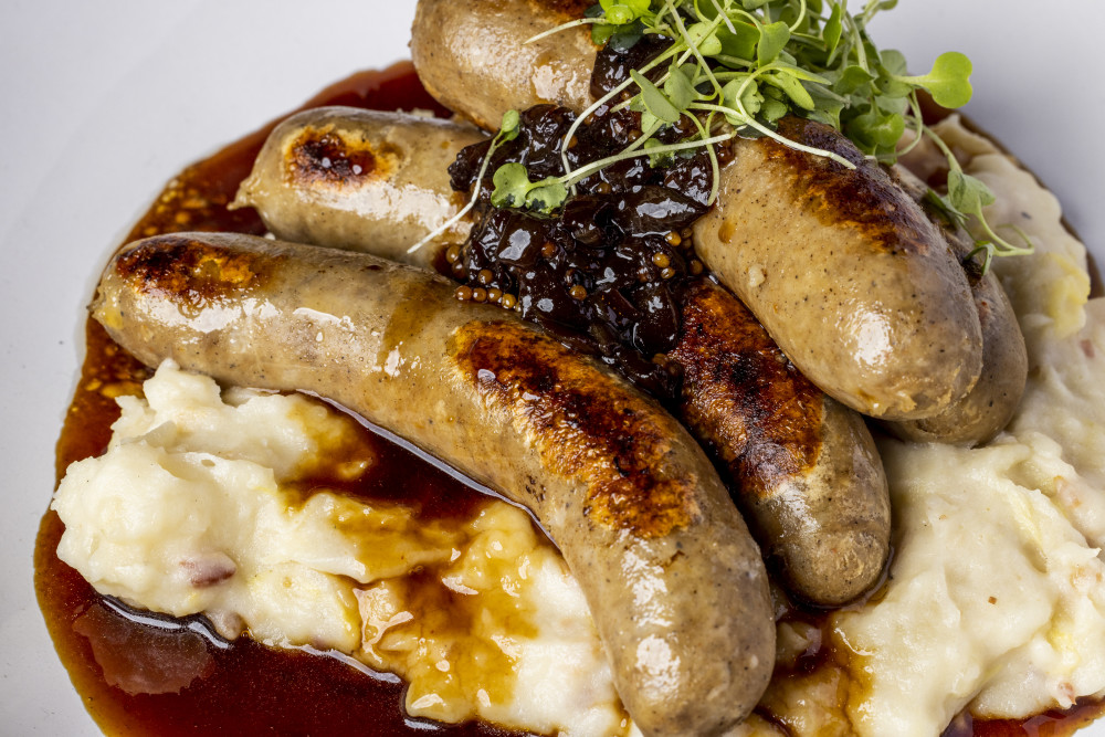 colcannon potatoes, Guinness brined sausage, caramelized onion, Irish gravy