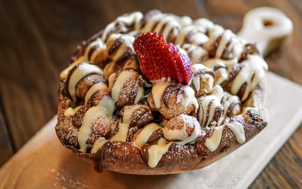 Bite-sized pieces of our signature pizza dough, lightly fried until golden, tossed in warm Nutella®and finished with a dusting of powdered sugar.