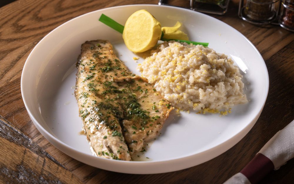 Pan-seared branzino served over creamy lemon risotto, delicately balanced with bright citrus flavors.