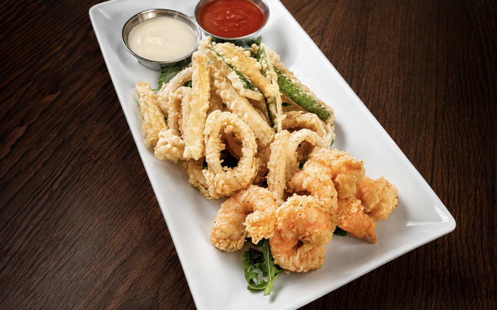 A crispy assortment of calamari, shrimp, and zucchini, lightly battered.