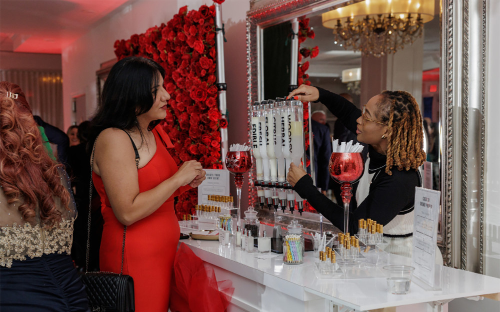 Personalized perfume blending at a glamorous event setup.