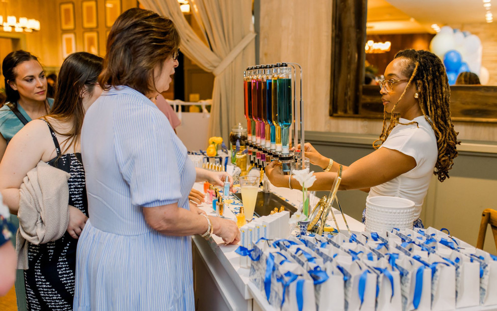 A guest explores custom scents at the elegant perfume bar.