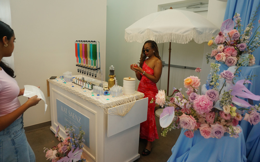 A vibrant fragrance station surrounded by pastel florals and coastal décor.
