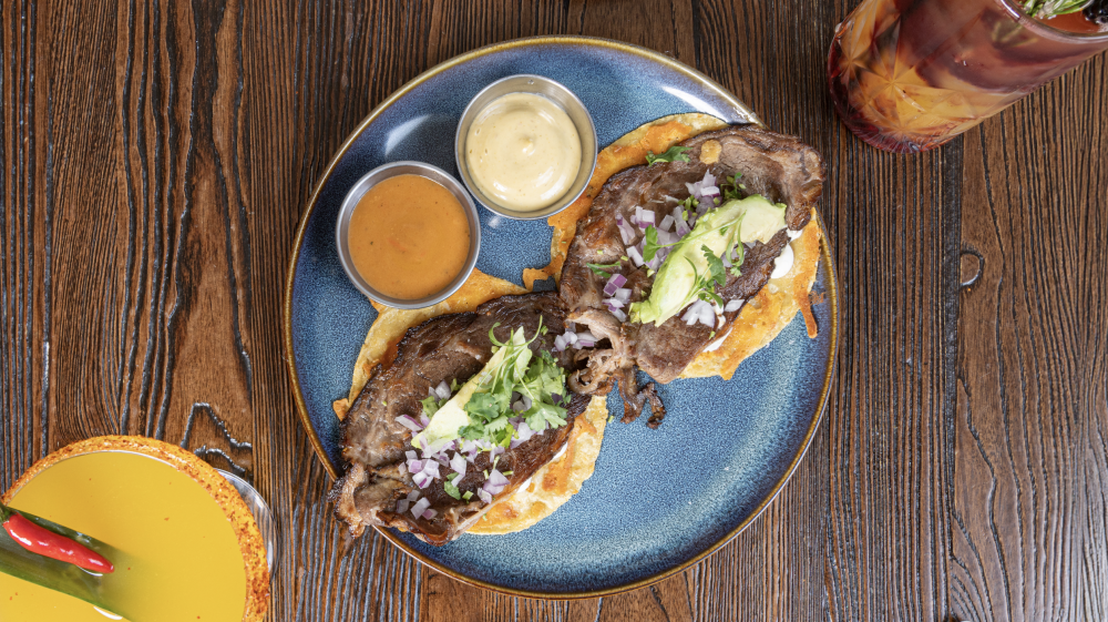 Chihuahua cheese crust, creamy beans, ribeye, avocado, white onions, cilantro, Mexican cream, Tulum sauce.