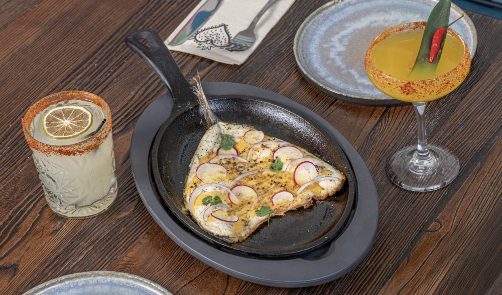 Guajillo & achiote salt-seasoned branzino with roast pineapple sauce, red onions, radish, and crispy sweet jalapeños. Includes one side of your choice