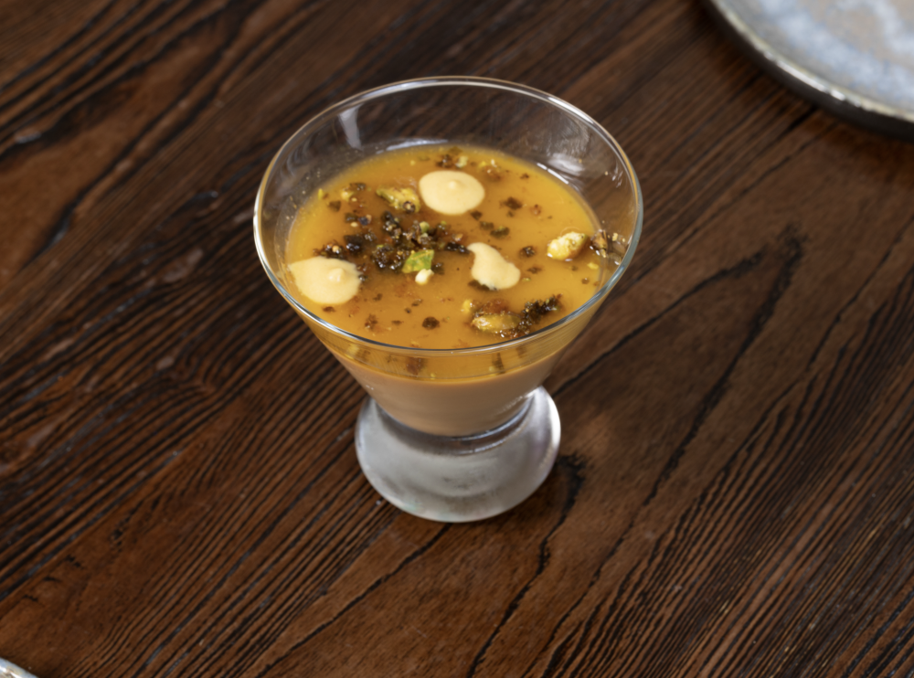 Creamy panna cotta with dulce de leche, topped with passion fruit syrup, caramelized pistachio, and sweet crunchy jalapeño.