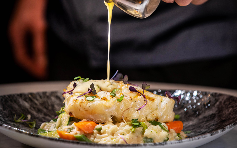 Served with a lemon-butter sauce and creamy vegetable risotto