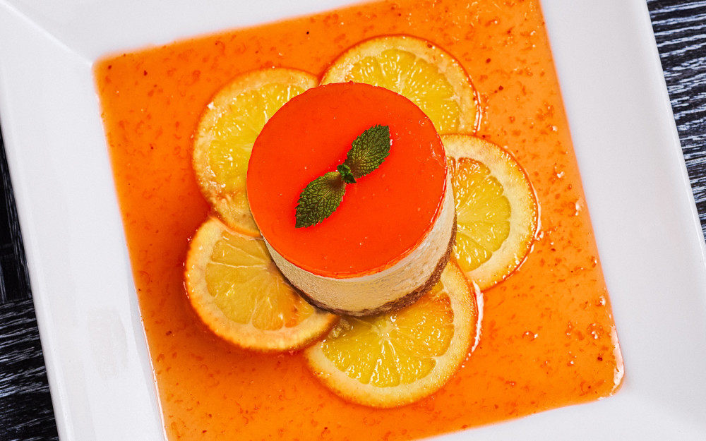 Orange vanilla cream cheesecake with sliced candied orange and sweet gelee