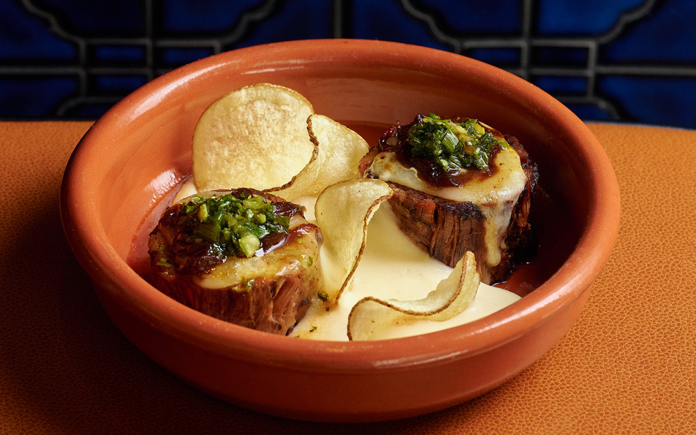 Braised short ribs, tetilla cheese, caramelized onions, homemade potato chips, salsa criolla, and potato foam.