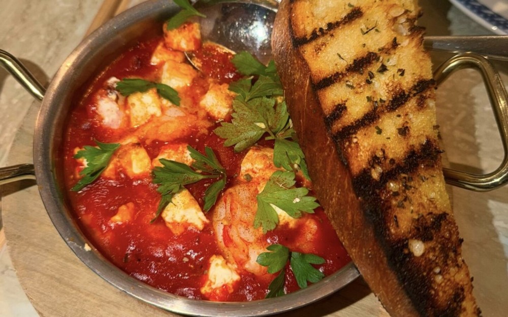 wild-caught shrimp cooked in savory tomato sauce with feta, splash of ouzo, served with grilled sourdough
