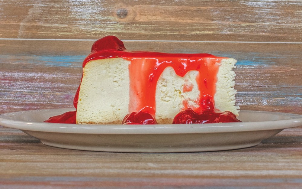Creamy, cheesecake filling, soft baked, with a buttery crust and a topping of strawberries and a sweet glaze sauce.