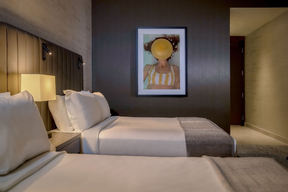 Embrace chic comfort and even more space with the Deluxe Double Queen room at Thesis.