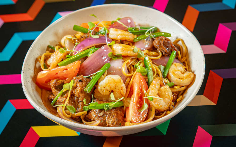 Tallarín Saltado Especial: chicken & shrimp, linguini wok-fried with red onion, tomato, & ají