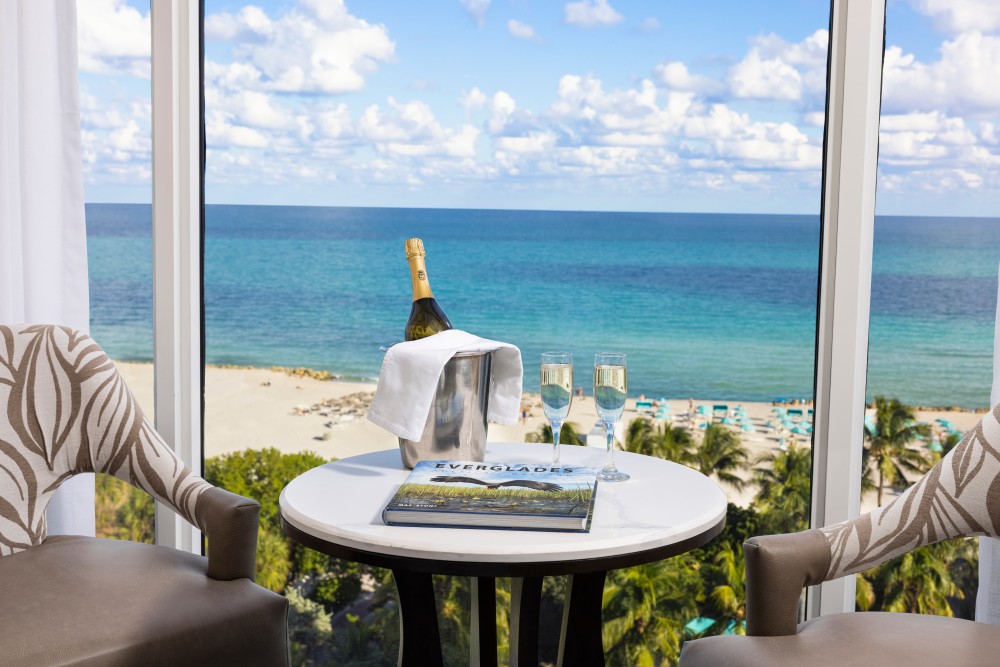 A light-filled oceanfront seating area offering panoramic Atlantic views—ideal for relaxing, sipping champagne, and soaking in the sea views.