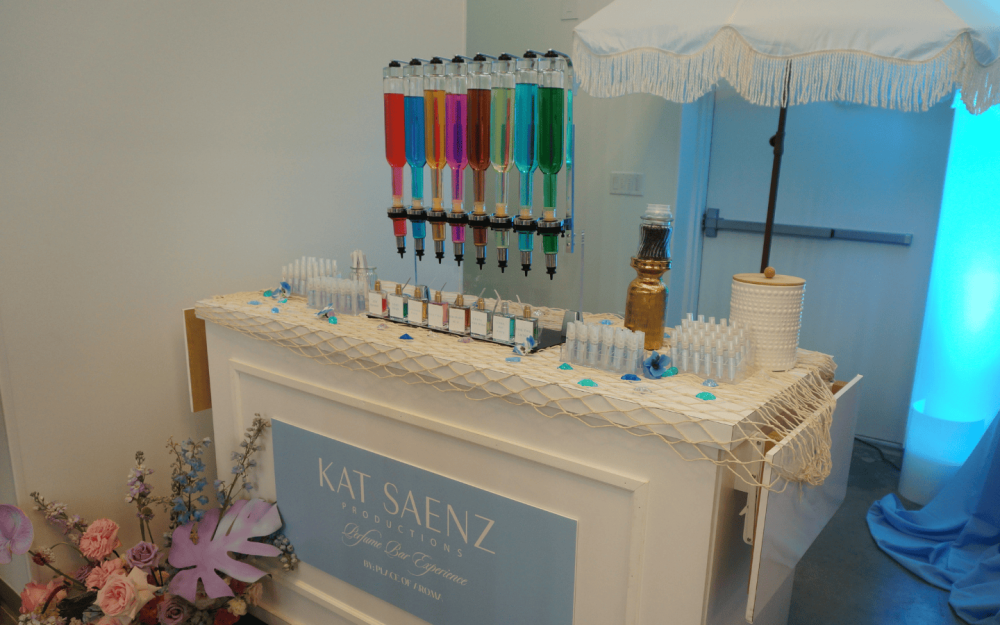 Coastal-themed perfume bar with colorful fragrance dispensers and custom scent stations.