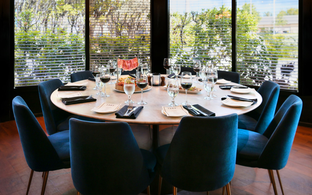Private room with capacity for 12 at a round table. Complimentary Smart TV mounted on the wall.